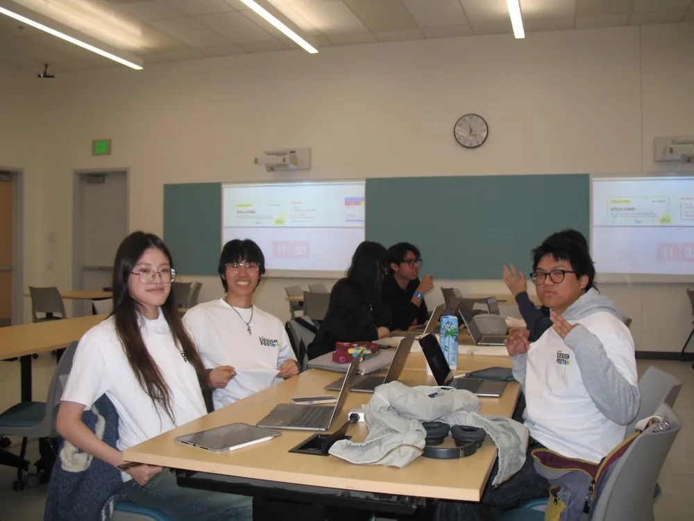 Classmates at a table with laptops