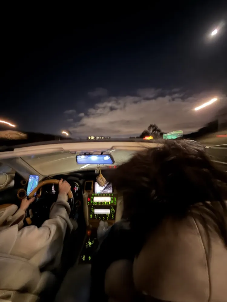 Riding in a car at night under the moon