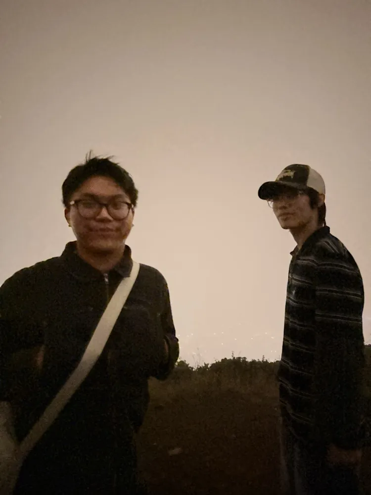 Two friends outside on a foggy night