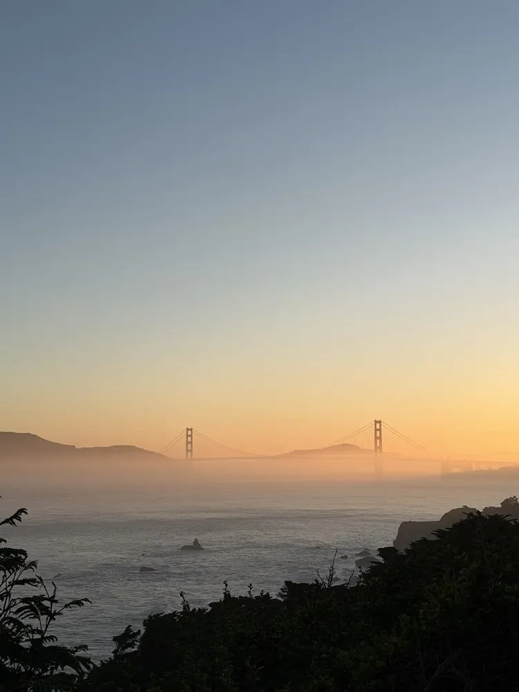 The Golden Gate Bridge in fog at sunset