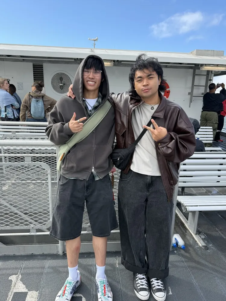 Two friends posing on a ferry deck