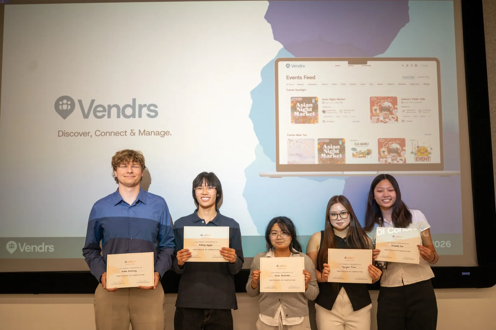 The Vendrs team holding certificates of completion, with the Events Feed shown on screen behind them